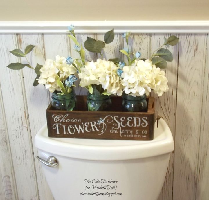 Rustic-basket-with-mason-jars-above-toilet