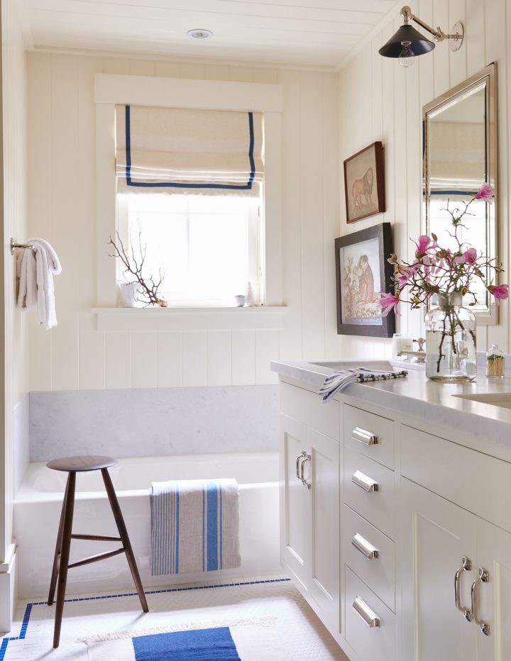 White-bathroom-with-beadboard-and-small-window-above-bathtub