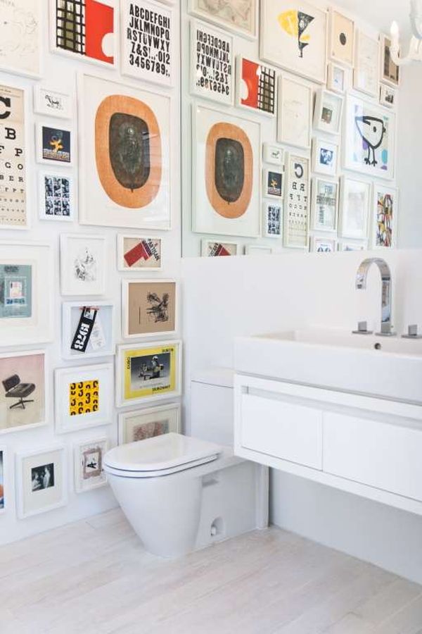 white-bathroom-decorated-frames