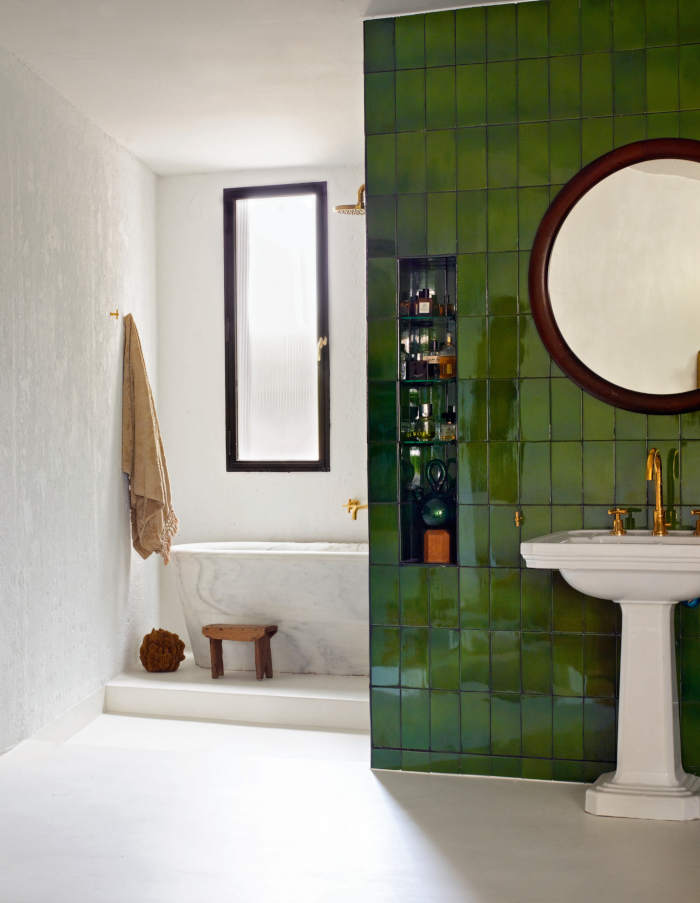 Modern-bathroom-with-green-tiles-and-freestanding-tuib