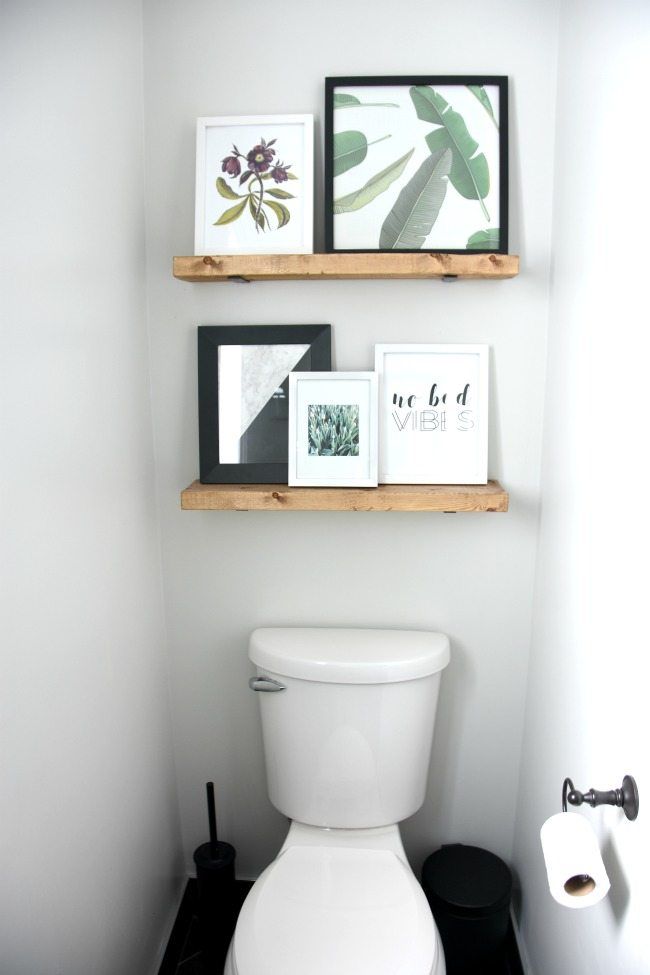 Display-art-over-toilet-with-shelves