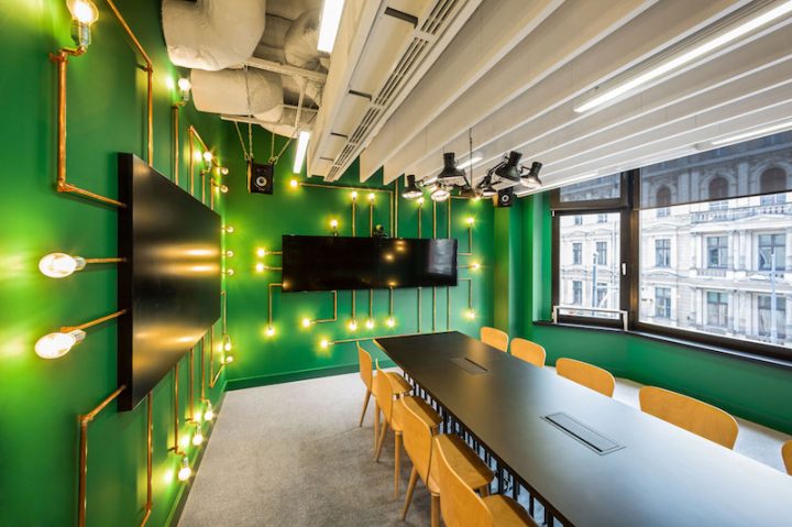 Opera-office-meeting-room-with-green-walls-and-pipe-lighting