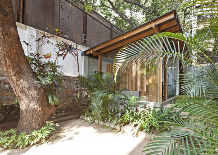 garden-pavilion-by-Abraham-John-Architects-with-lush-vegetation